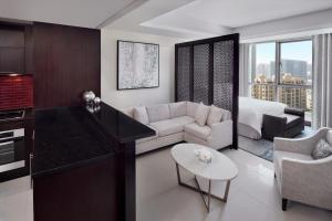 a living room filled with furniture and a large window at Address Downtown in Dubai