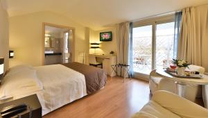 a hotel room with a bed and a table and a kitchen at Regal Residence in Brescia