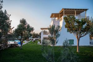 a house with a yard with trees in front of it at JKG OIKIA in Agia Anna Naxos