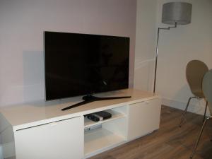 a flat screen tv sitting on a white entertainment center at Westpark Apartment in East Kilbride