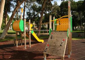 a playground with a slide in a park at INATEL Caparica in Costa da Caparica