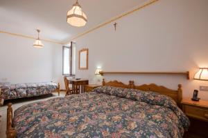 Ένα ή περισσότερα κρεβάτια σε δωμάτιο στο GH Hotel Fratazza