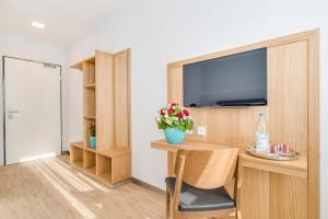 TV a/nebo společenská místnost v ubytování Hotel-Etage Apfelrot