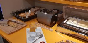 a counter with bread and a toaster on a table at Royal Hotel Versailles in Versailles