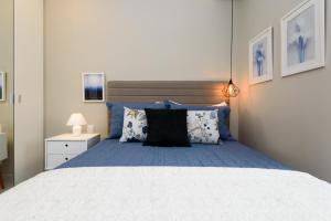 a bedroom with a large bed with blue sheets and pillows at Studio em Copacabana a 180m da praia | RP 23/404 in Rio de Janeiro