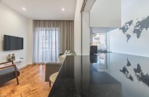a living room with a table and a world map on the wall at Marquês de Pombal Metropolitan Flat in Lisbon