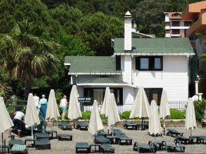 a group of chairs and umbrellas in front of a building at Beachwood Villas in Marmaris