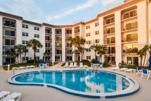 an image of a swimming pool in front of a building at Daytona Beach Shores Condos in Daytona Beach Shores