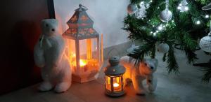 two teddy bears standing next to a lantern and a christmas tree at Marselo B&B in Bari