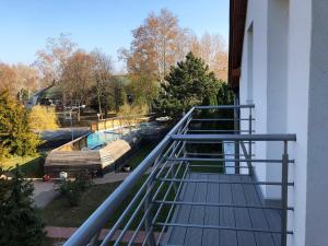 a balcony with a view of a swimming pool at Hotel Aqua in Komárom