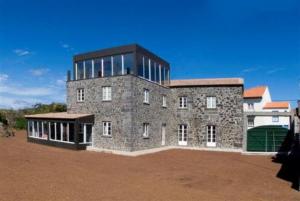 a rendering of a stone building in a field at Casa Das Faias in Santa Cruz da Graciosa