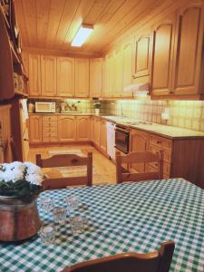 a kitchen with a table with a green and white table cloth at Rehto in Rovaniemi