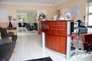 a reception desk in a lobby with a salon at Shoes Guest House in Mthatha