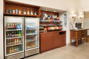 a room with a refrigerator with drinks in it at Country Inn & Suites by Radisson, Des Moines West, IA in Clive