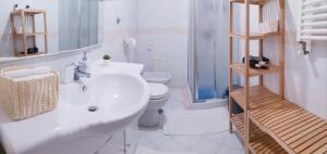 a bathroom with a white sink and a toilet at Casa vacanze Caterina in Naples +34 photos
