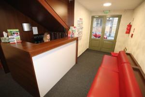 a woman sitting at a bar in a restaurant at Hotel California in Budapest