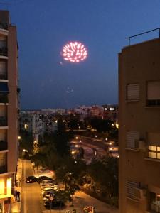 a firework display in the sky over a city at night at centro / internet / parking / aire acondicionado in Elche