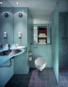 
a bathroom with a toilet a sink and a shower at Holiday Inn London West, an IHG Hotel in London

