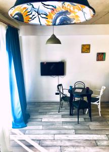 a dining room with a table and chairs and a tv at City Center Loft by Happy Place in Tbilisi City