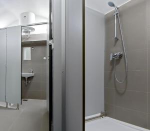 a bathroom with a shower with a glass door at Apartments Bisernica-with pool in Ražanj