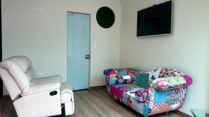 a living room with a couch and a chair at Vincent Suites Hotel in Pasto +7 photos