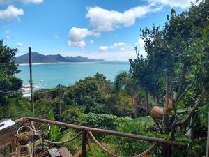 a view of the ocean from a balcony at Hostel do Morro in Florianópolis