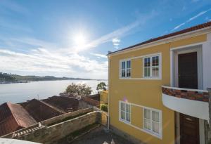 a yellow building with a view of the water at Porto D'Ouro Apartment in Porto +47 photos