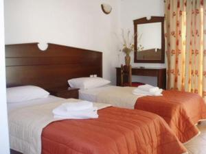Postel nebo postele na pokoji v ubytování Rita's Place Hotel