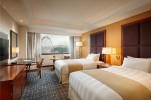 Postel nebo postele na pokoji v ubytování Lotte Hotel Ulsan