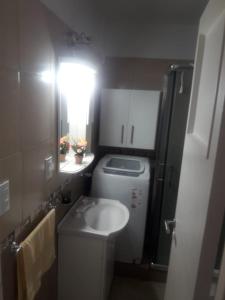 a small bathroom with a sink and a refrigerator at Depto sobre Peatonal San Martin in Mar del Plata