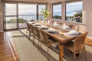 a dining room with a long wooden table and chairs at Top of the Hill in Yallingup