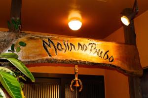 a sign that says monday no friday hanging from a ceiling at Majin No Tsubo in Nakijin