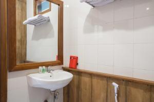 a bathroom with a sink and a mirror at RedDoorz near Baluran National Park in Pandean