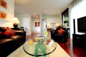 a living room with a glass table in a living room at Kata Gardens 2 bedroom near beach in Kata Beach