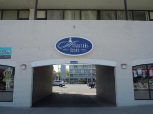 a building with a sign that reads plants and inn at Atlantis Inn in Rehoboth Beach