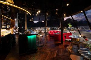 a man standing at a bar in a restaurant at Stellar of the Seas Cruise in Ha Long