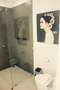 a bathroom with a shower and a picture of a woman at Villa Rahul in Bophut 