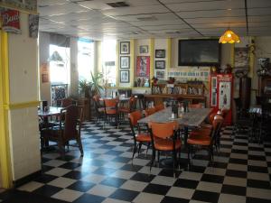 
a restaurant with tables, chairs, and tables in it at Stagecoach 66 Motel in Seligman
