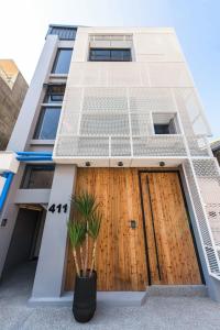 a building with a wooden door and a plant at H suite Go in Changhua City