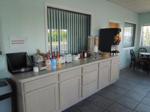 a kitchen with a counter with a microwave and a tv at Atlantic Inn in Millsboro