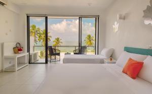 a bedroom with a bed and a view of the ocean at Hotel J Ambalangoda in Ambalangoda