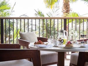 a table with plates of food on a balcony at Jumeirah Al Naseem Dubai in Dubai