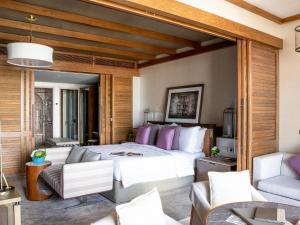 a bedroom with a large bed and a couch at Jumeirah Al Naseem Dubai in Dubai