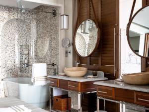 a bathroom with two sinks and a large mirror at Jumeirah Al Naseem Dubai in Dubai