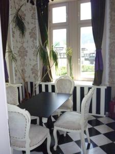 a dining room with a table and chairs and a window at Vilele Lucia Luxury Mens Sana in Sinaia