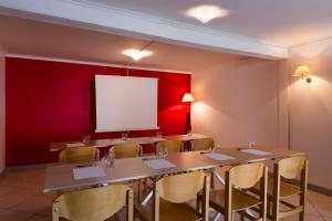 a conference room with a long table and chairs at The Originals Access, Hôtel Figeac in Figeac
