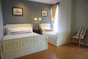 Postel nebo postele na pokoji v ubytování Nai Suan Bed and Breakfast