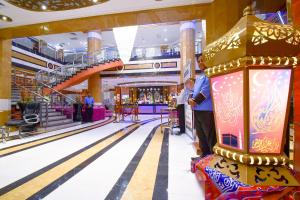 a man is standing in a bowling alley at Golden Tulip Al Shakreen in Medina