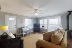 a living room with a couch and a ceiling fan at Westport Marina View in Westport