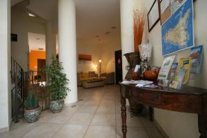 a hallway with a desk in a building at Zingaro Hotel in San Vito lo Capo